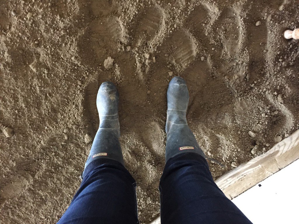 Feet stuffed in small Hunter boots. 